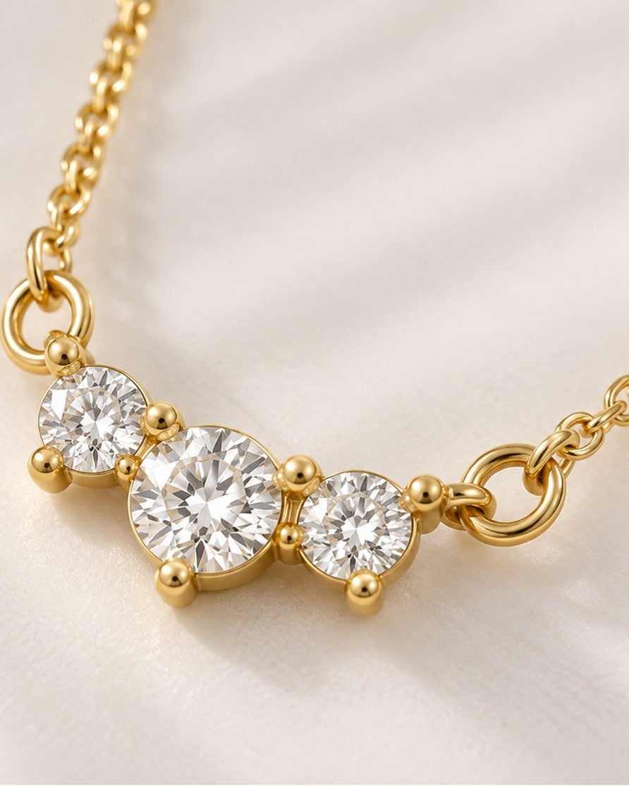 Elli Jewellery gold plated trilogy necklace featuring three brilliant-cut cubic zirconia stones on a delicate chain.