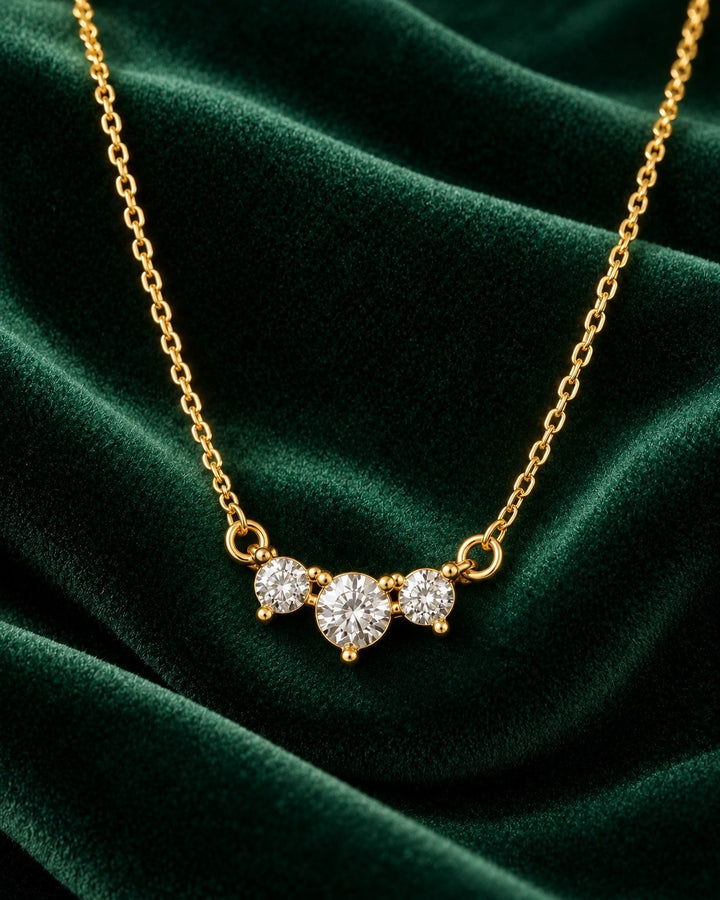Elli Jewellery gold plated trilogy necklace featuring three brilliant-cut cubic zirconia stones on a delicate chain.
