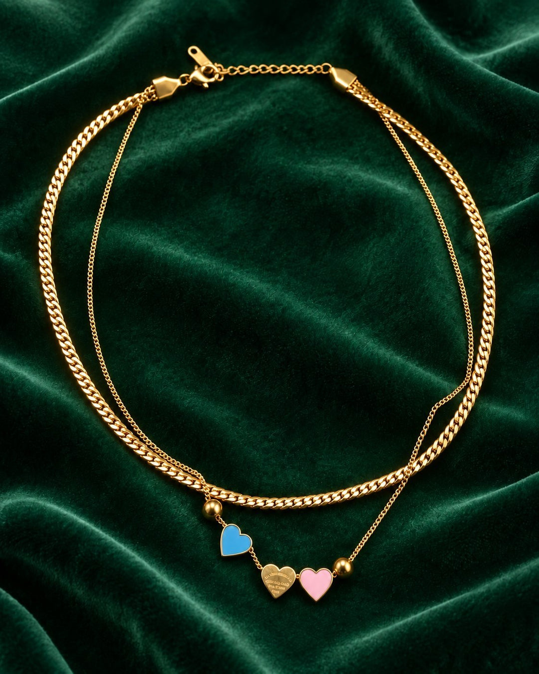 Elli Jewellery gold plated layered chain necklace featuring three delicate heart charms in blue, gold, and pink.