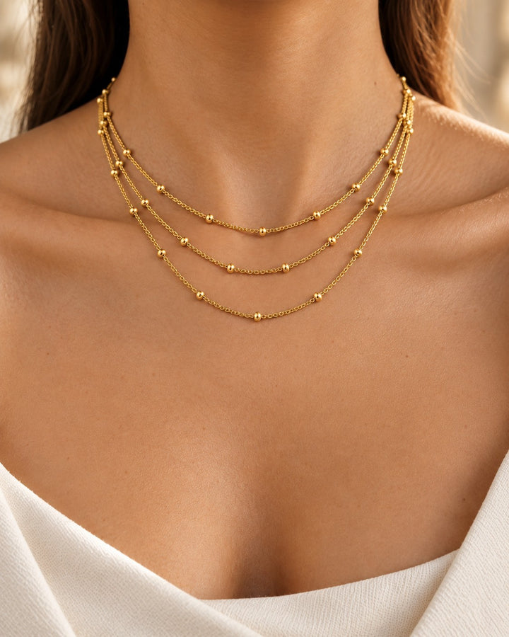 Elli Jewellery gold plated triple layered chain necklace with delicate bead details worn by a woman