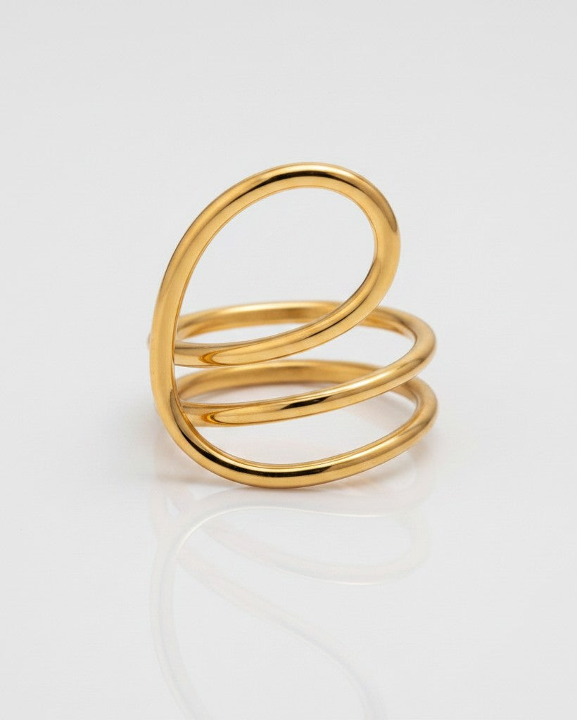 Elli Jewellery gold-toned statement ring featuring a sculptural twisted dome design with a smooth, polished finish.