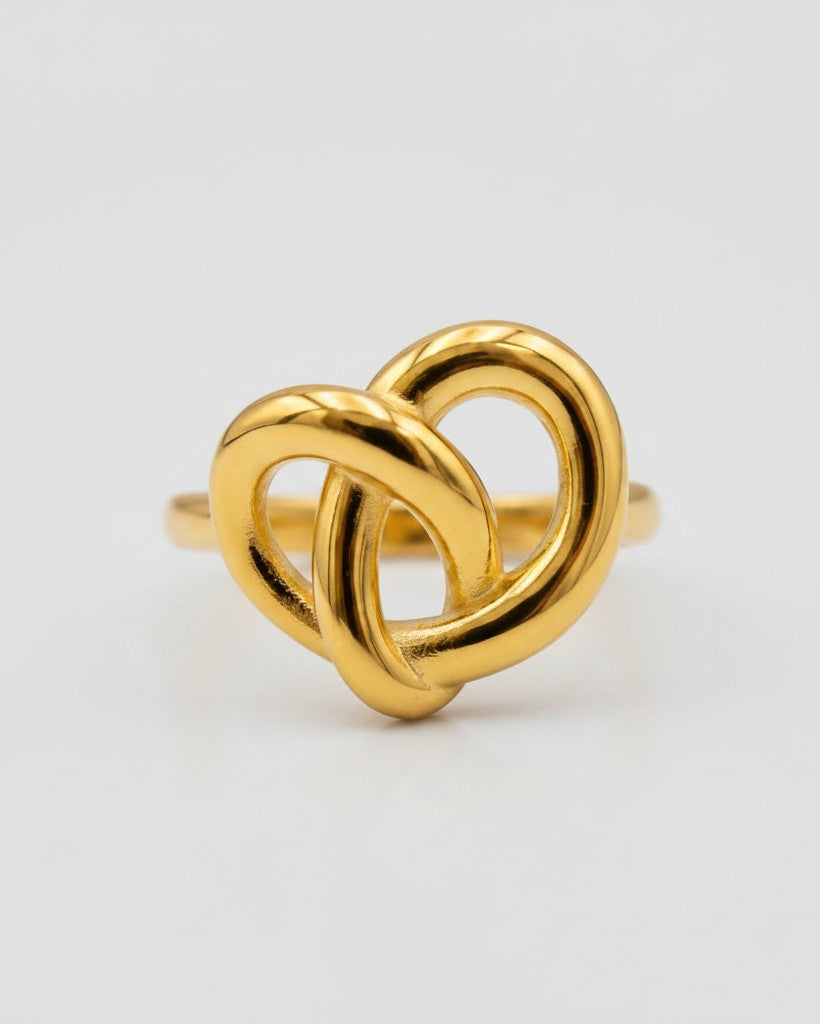 Elli Jewellery gold plated statement ring featuring a sculptural twisted knot design on a clean white background