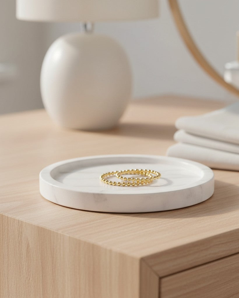 Elli Jewellery gold plated double stack ring with a twisted rope design resting on a white marble tray.