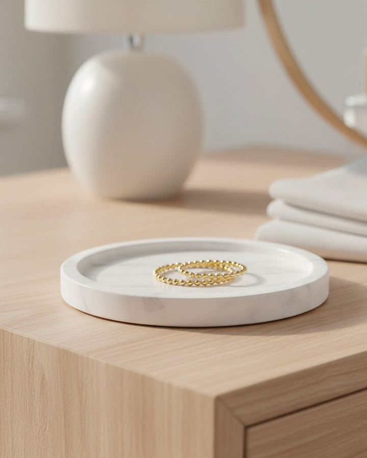 Elli Jewellery gold plated double stack ring with a twisted rope design resting on a white marble tray.