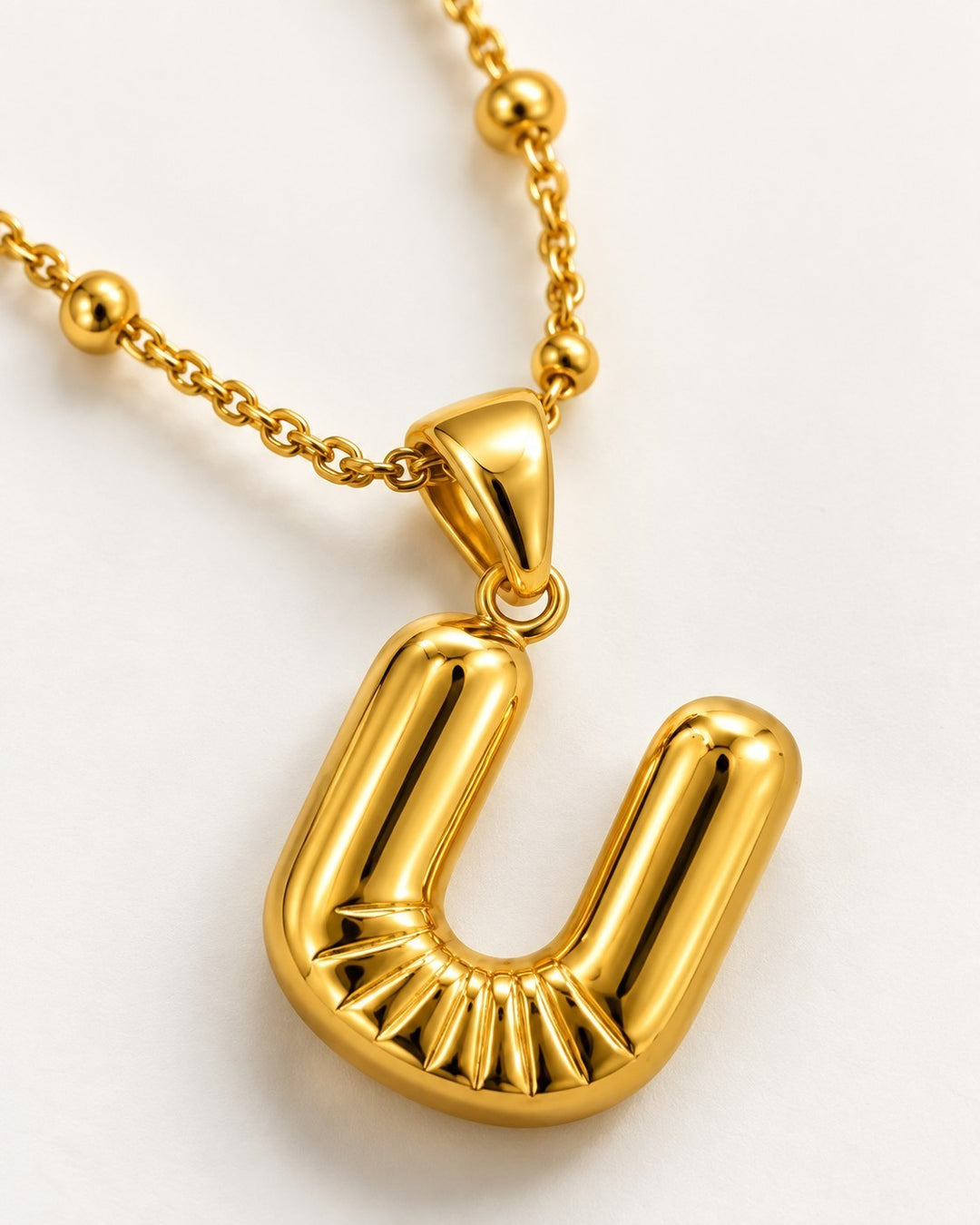 Elli Jewellery gold plated waterproof chunky chain necklace featuring a sculptural U initial pendant