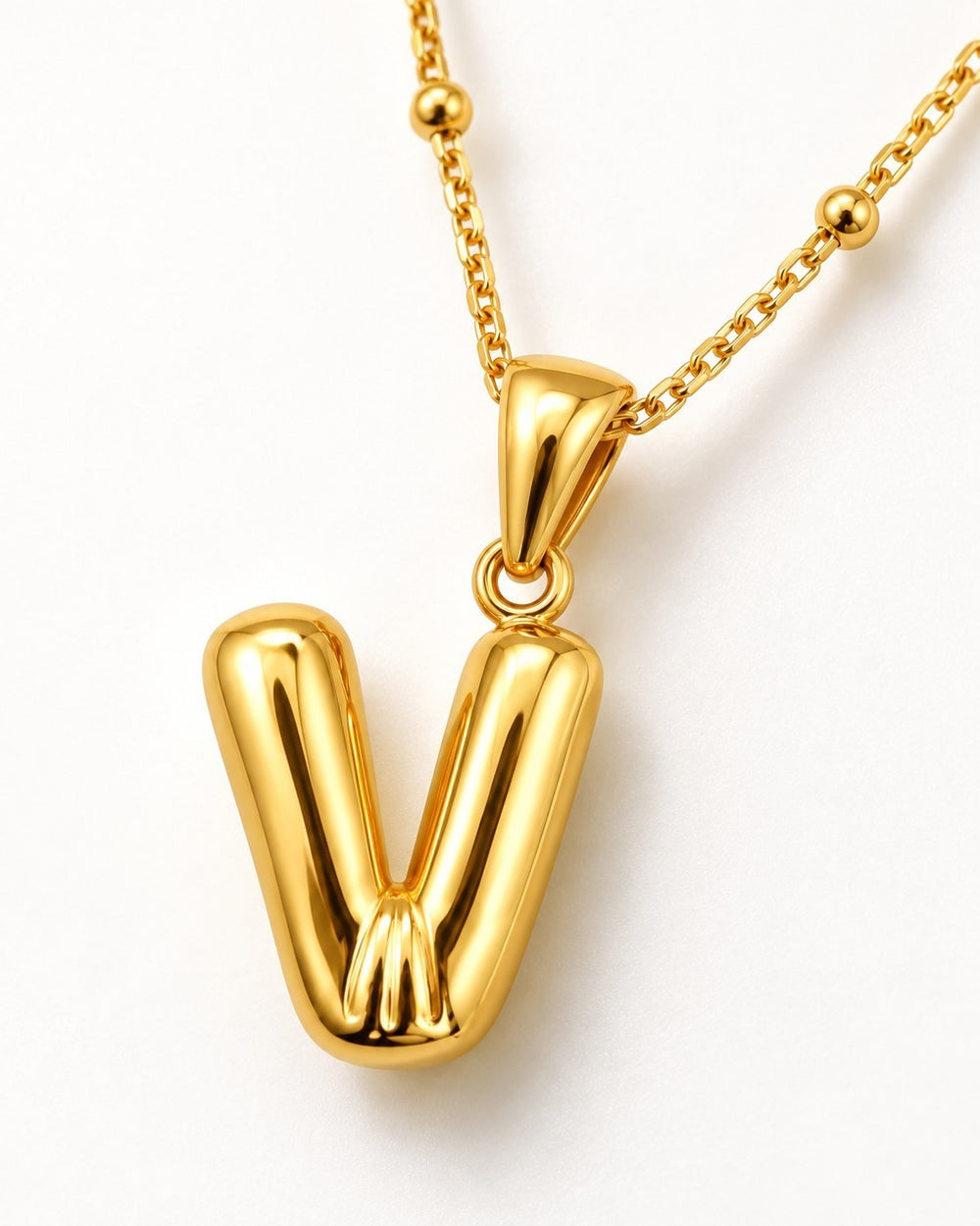 Elli Jewellery gold plated waterproof chunky V pendant necklace on a delicate beaded chain against a white background.