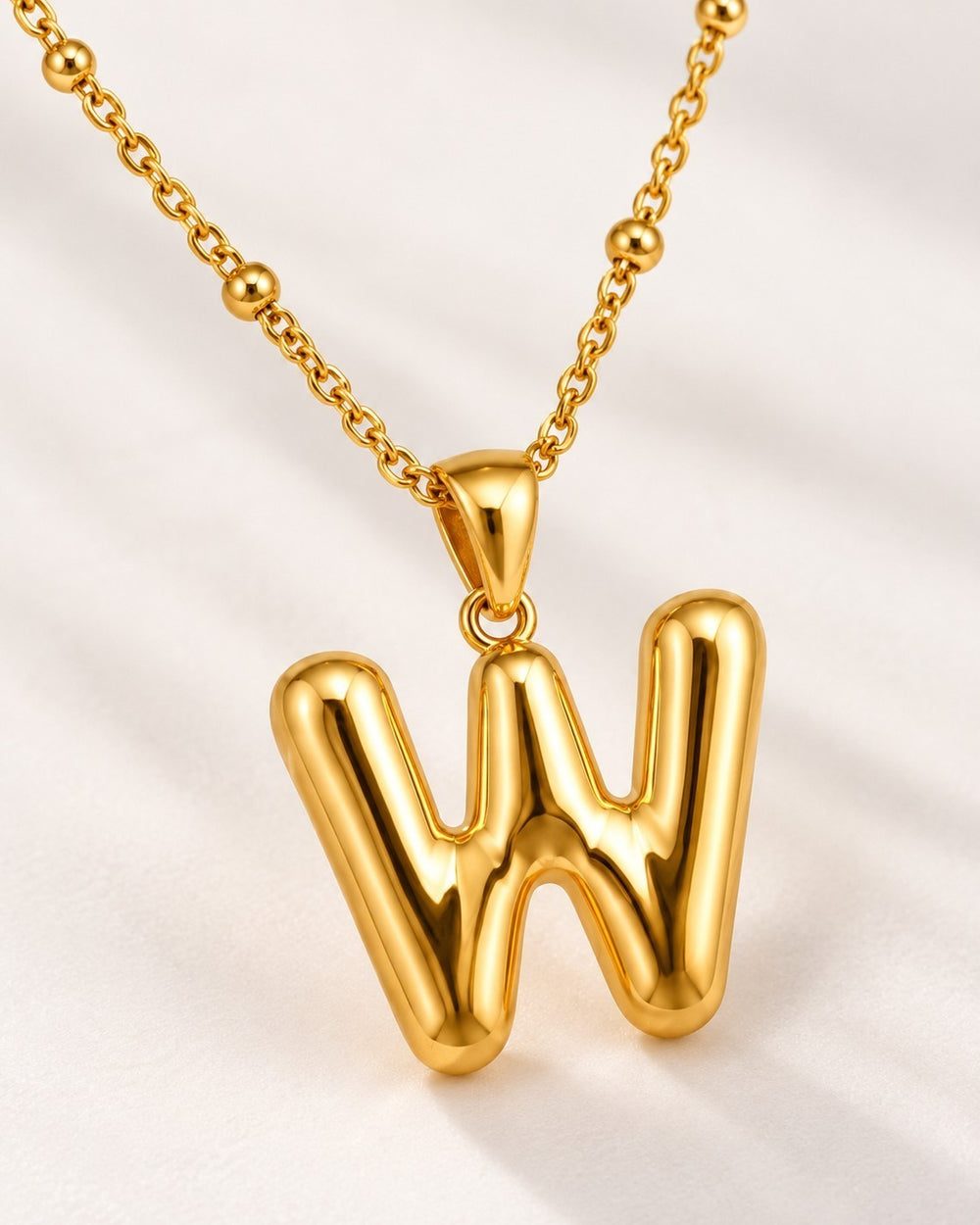 Elli Jewellery gold plated chunky chain necklace featuring a polished oversized letter W initial pendant