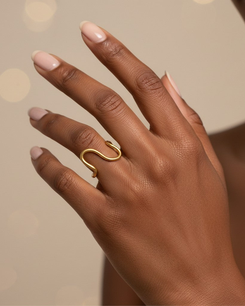 Elli Jewellery gold plated waterproof curved wave band ring worn on a finger with a minimalist aesthetic