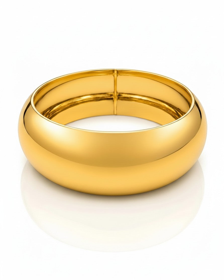 Elli Jewellery wide gold plated statement bangle bracelet with a polished, waterproof finish on a white background.