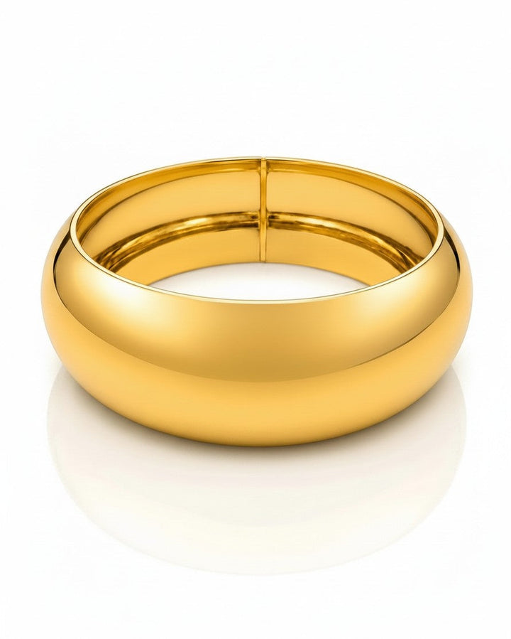 Elli Jewellery wide gold plated statement bangle bracelet with a polished, waterproof finish on a white background.