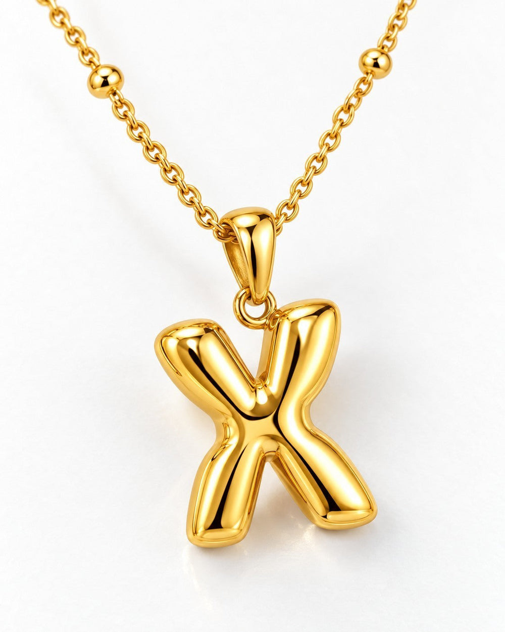 Elli Jewellery gold plated waterproof chunky X link pendant necklace on a delicate chain against a white background.