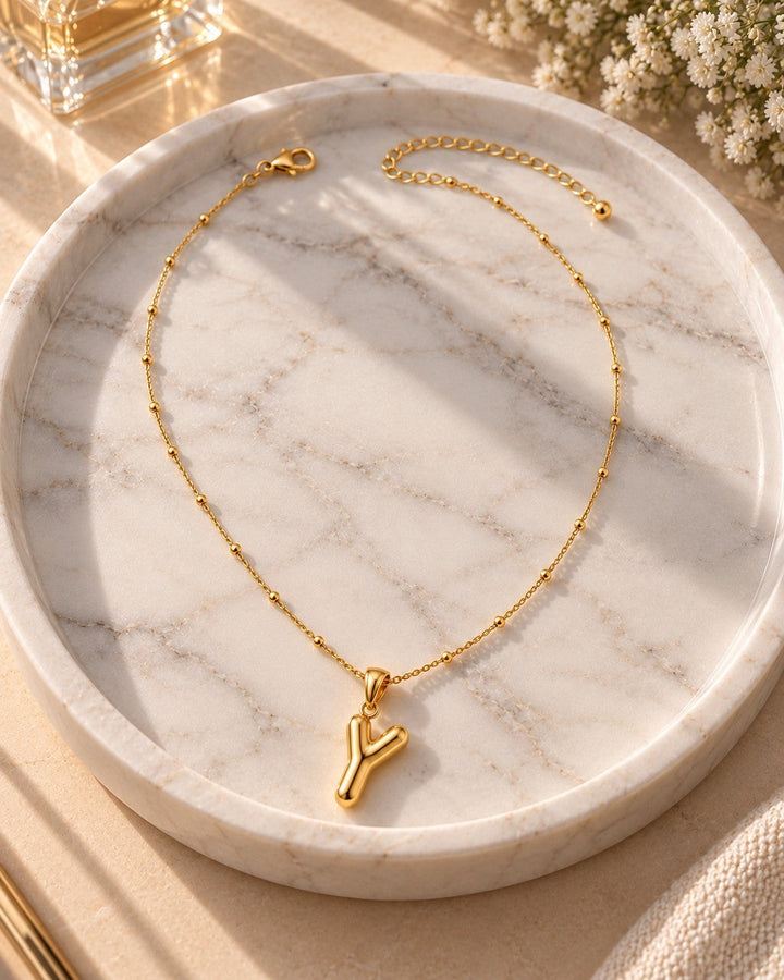 Elli Jewellery gold plated waterproof chunky Y-drop necklace on a marble tray with delicate bead chain detail