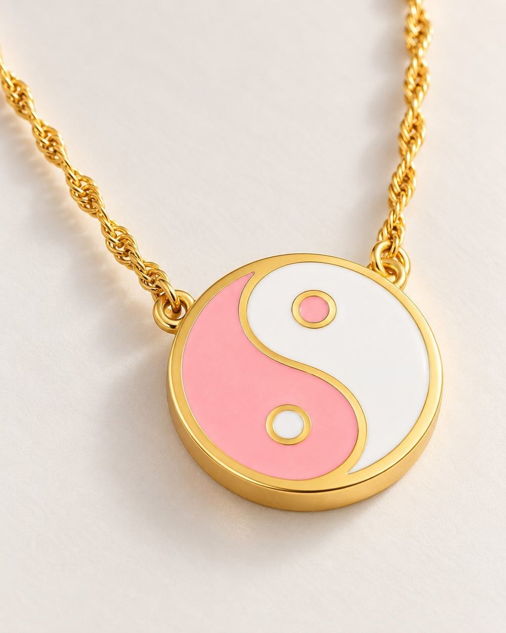 Elli Jewellery gold plated yin yang pendant necklace featuring pink and white enamel on a delicate twisted chain