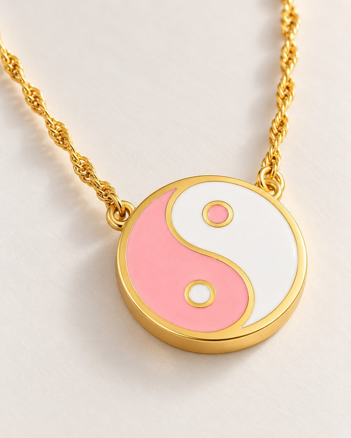 Elli Jewellery gold plated yin yang pendant necklace featuring pink and white enamel on a delicate twisted chain