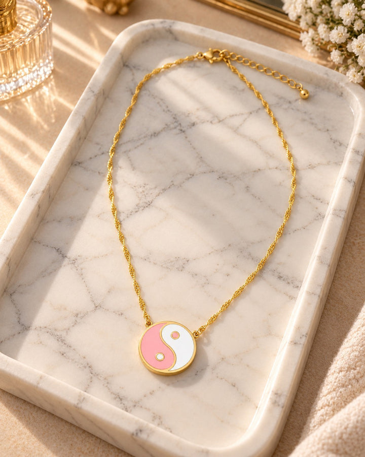 Elli Jewellery gold plated necklace featuring a pink and white enamel yin yang pendant on a delicate twisted chain.