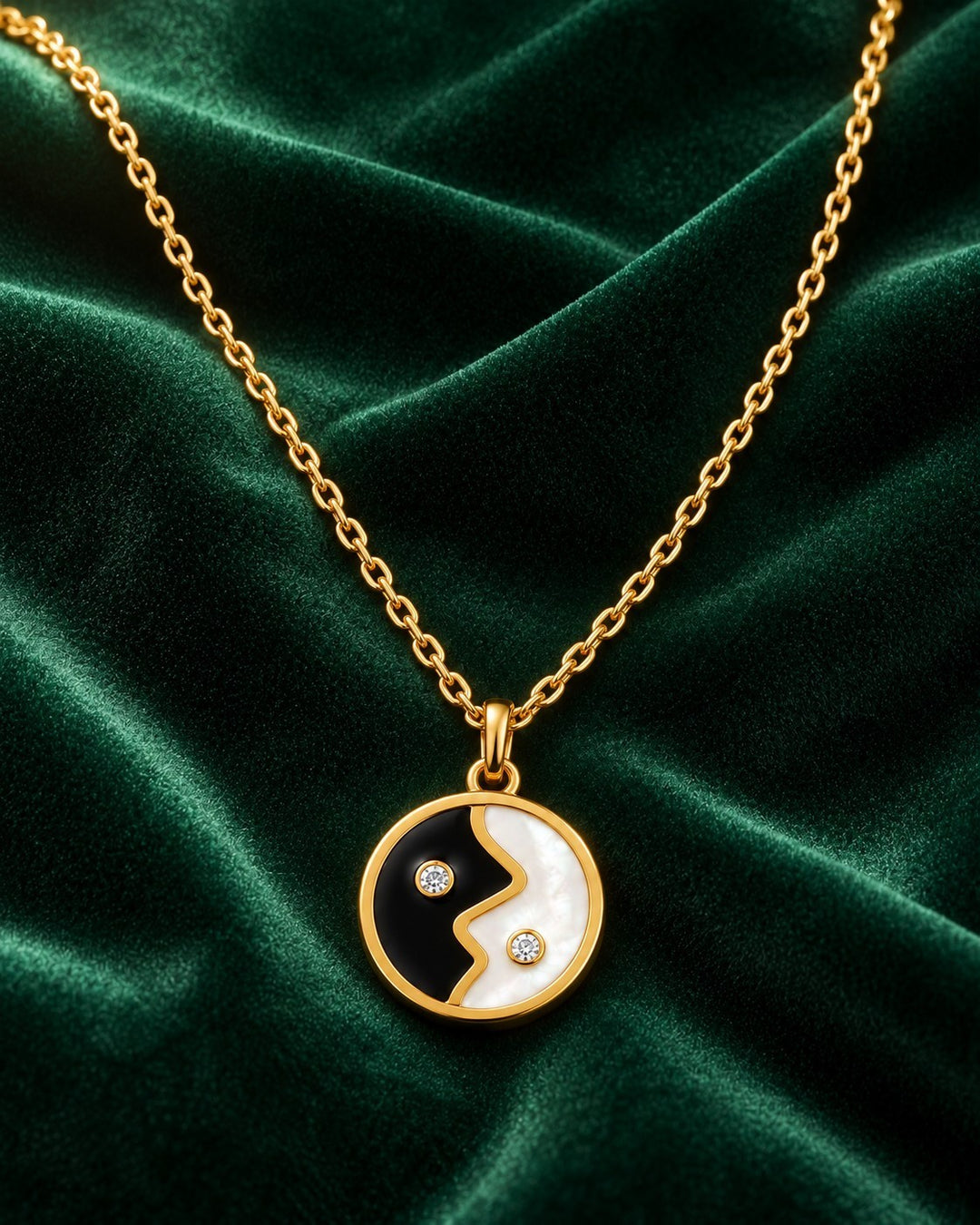 Elli Jewellery gold plated yin yang pendant necklace with black and white enamel and small sparkling crystal accents.