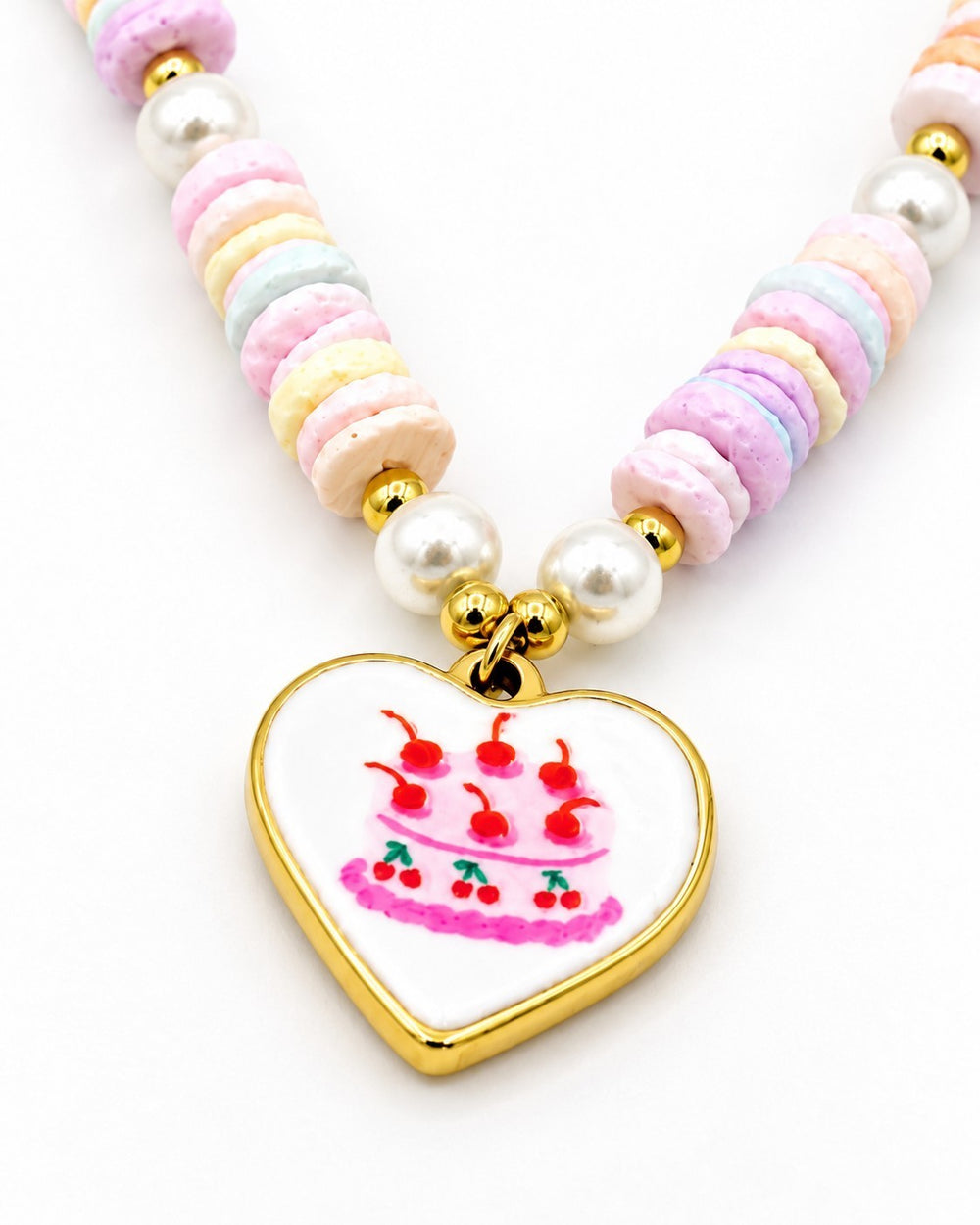 Elli Jewellery gold plated heart pendant necklace featuring a cake illustration with pastel beads and faux pearls