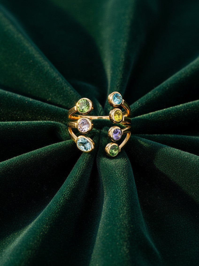 Elli Jewellery gold plated statement ring featuring seven vibrant bezel-set multi-coloured crystals on a velvet base