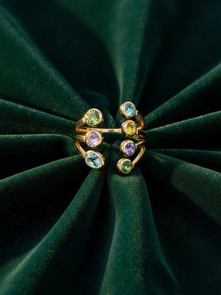 Elli Jewellery gold plated statement ring featuring seven vibrant bezel-set multi-coloured crystals on a velvet base