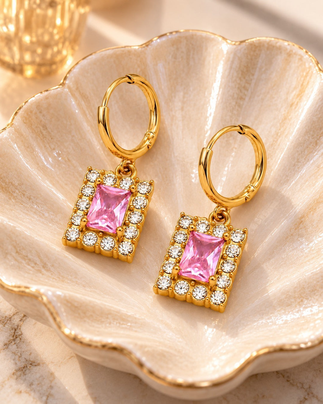 Elli Jewellery gold plated huggie hoop earrings featuring rectangular pink cubic zirconia stones and clear crystals.