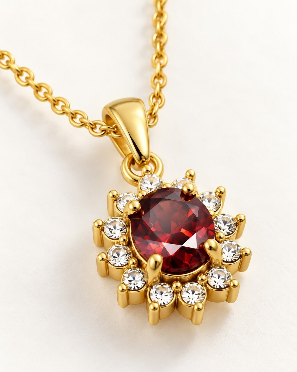 Elli Jewellery gold-plated statement necklace featuring a vibrant red crystal surrounded by sparkling white diamantes.
