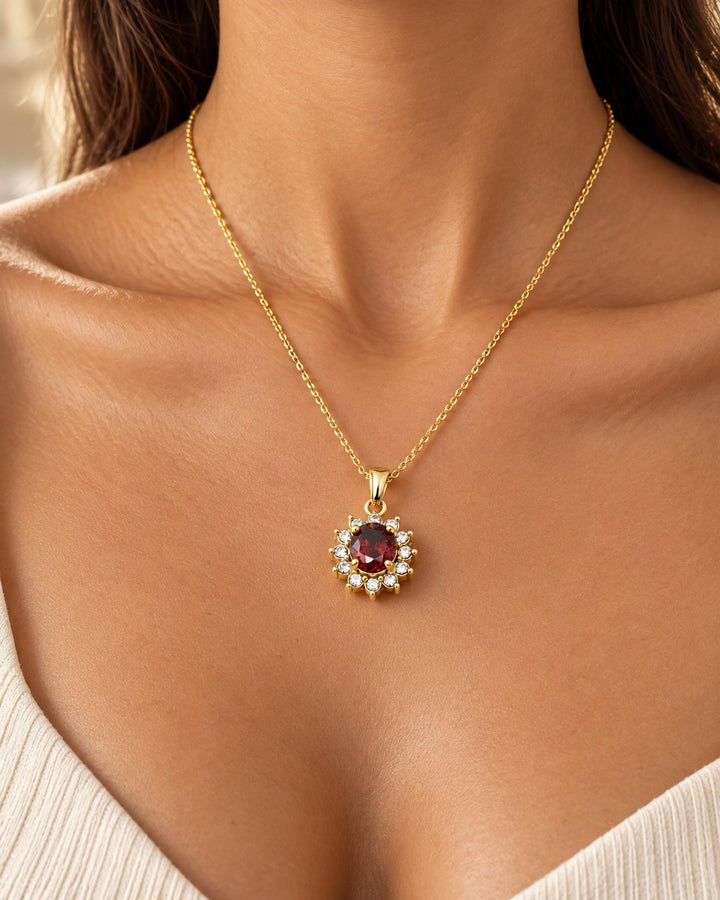 Elli Jewellery gold-plated necklace featuring a vibrant red crystal surrounded by sparkling diamante stones