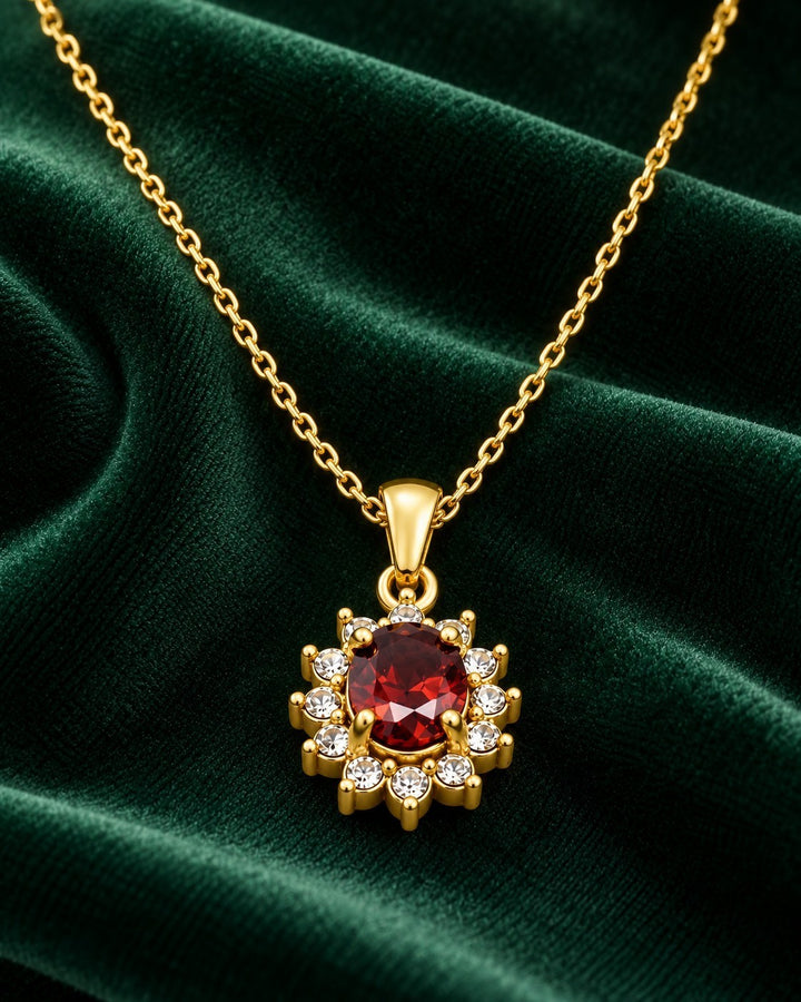 Elli Jewellery gold-plated statement necklace featuring a vibrant red crystal surrounded by sparkling diamante stones.