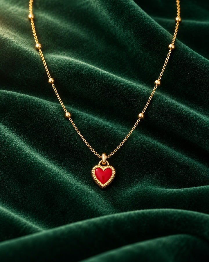 Elli Jewellery gold plated necklace featuring a dainty red enamel heart pendant on a delicate beaded chain.
