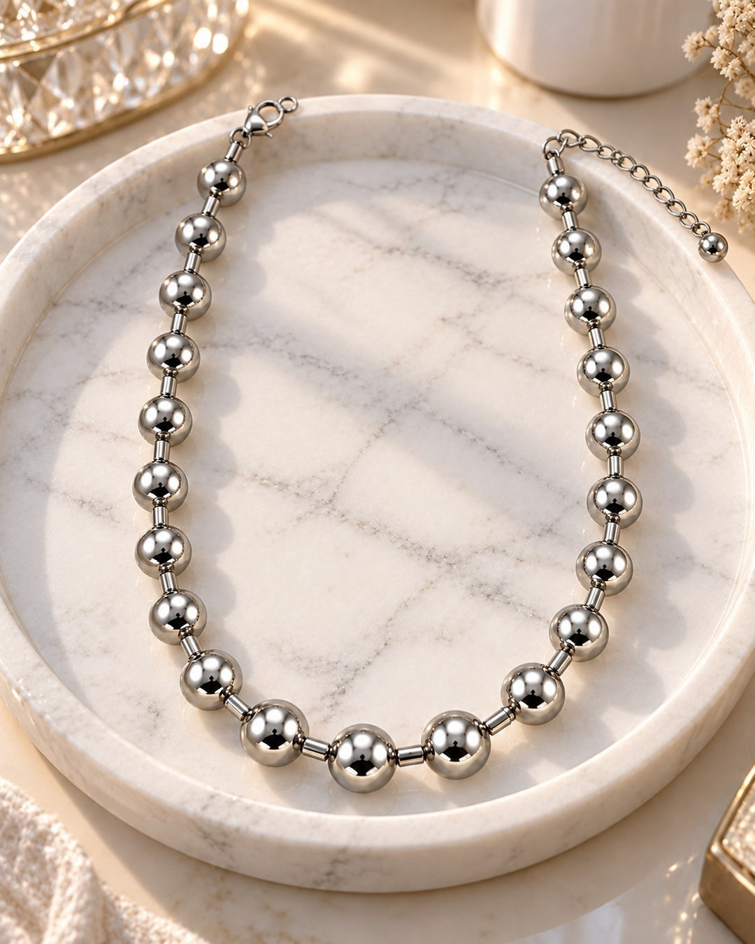 Elli Jewellery rhodium plated chunky ball chain necklace with a high-shine silver finish on a marble display tray.