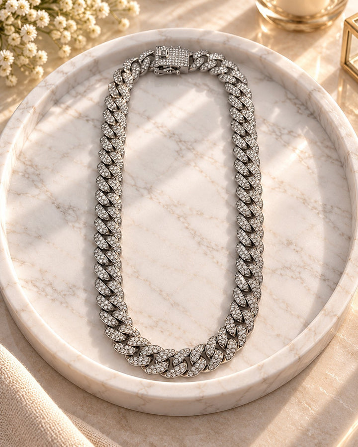 Elli Jewellery rhodium plated chunky curb chain necklace featuring sparkling crystal embellishments on a marble tray.
