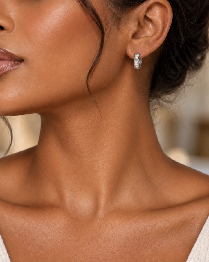 Elli Jewellery rhodium plated hoop earrings with sparkling diamante stones worn by a woman