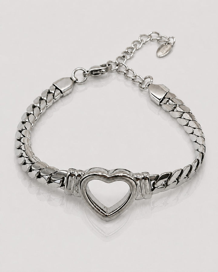 Elli Jewellery rhodium plated Cuban link bracelet featuring a central open heart charm on a white background.