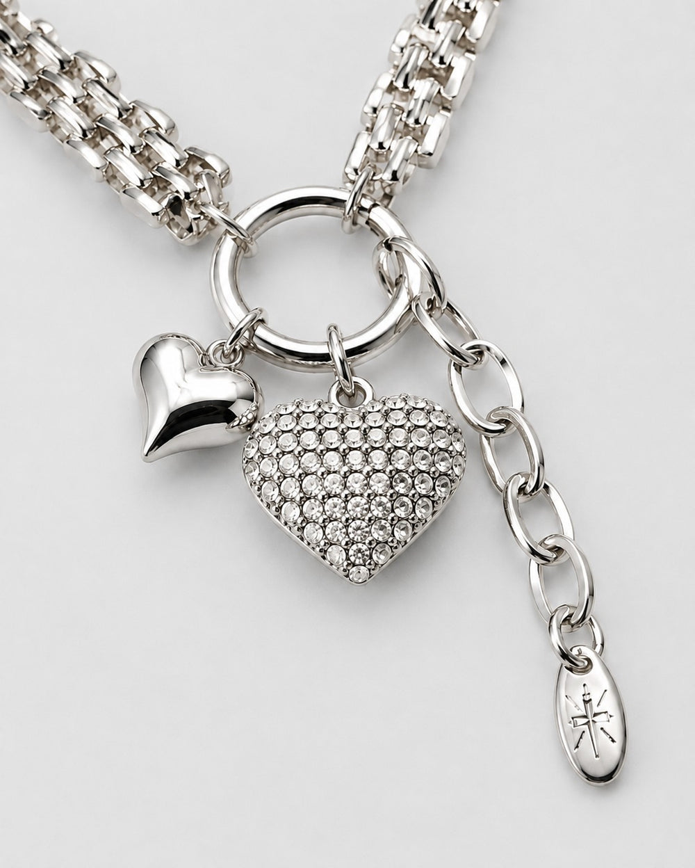 Elli Jewellery rhodium plated necklace featuring a polished heart charm and a crystal-encrusted heart pendant.