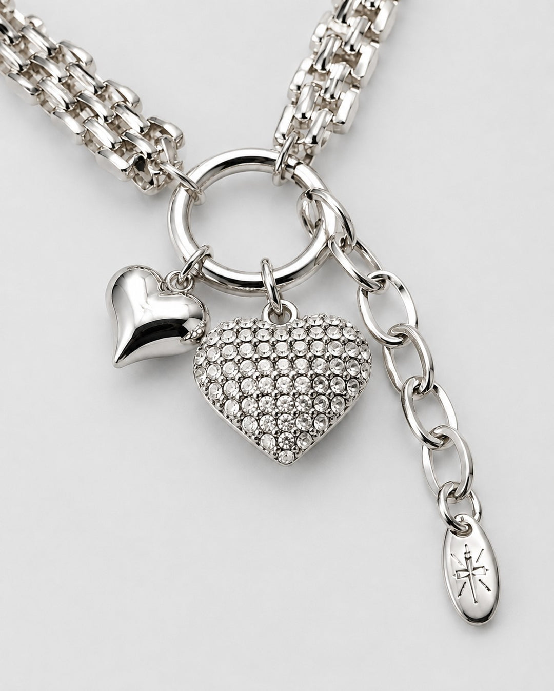 Elli Jewellery rhodium plated necklace featuring a polished heart charm and a crystal-encrusted heart pendant.