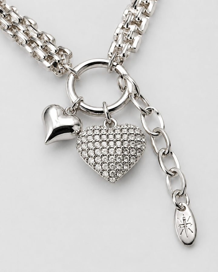 Elli Jewellery rhodium plated necklace featuring a polished heart charm and a crystal-encrusted heart pendant.