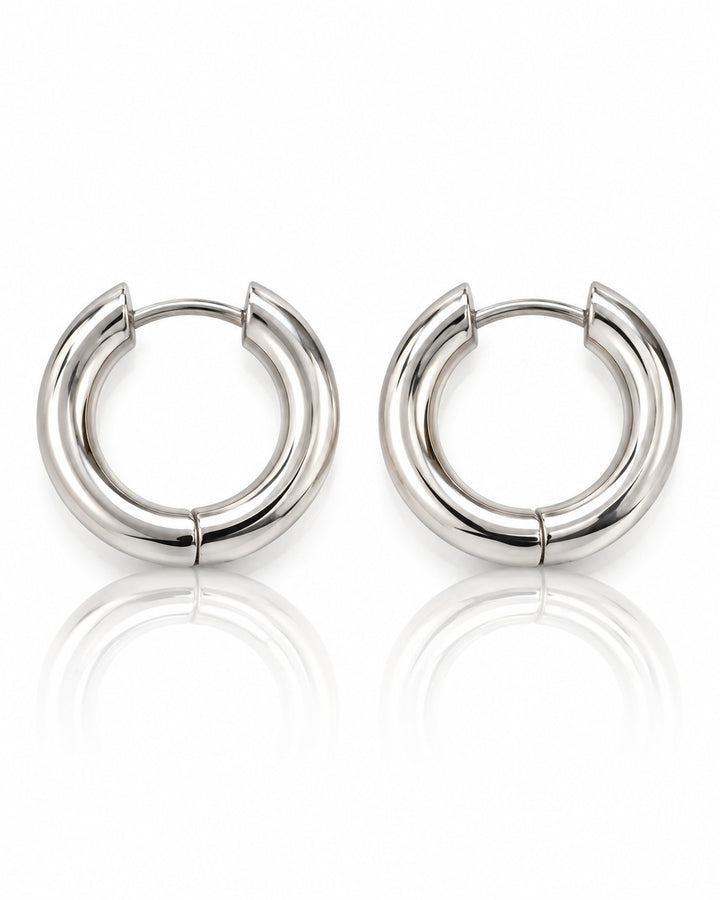 Elli Jewellery rhodium plated waterproof mid huggie hoop earrings with a polished silver finish on a white background.