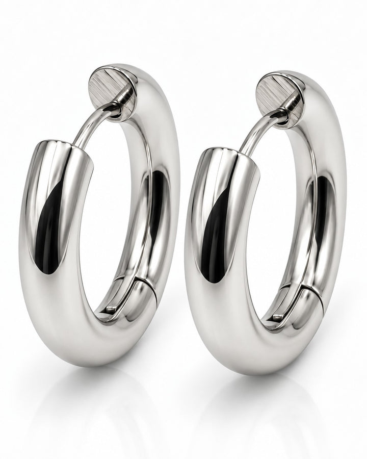 Elli Jewellery rhodium plated waterproof huggie hoop earrings with a polished silver-toned finish and hinged closure.