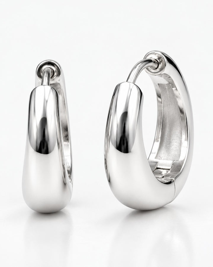 Elli Jewellery rhodium plated minimalist huggie hoop earrings with a polished silver finish and secure hinged clasp.