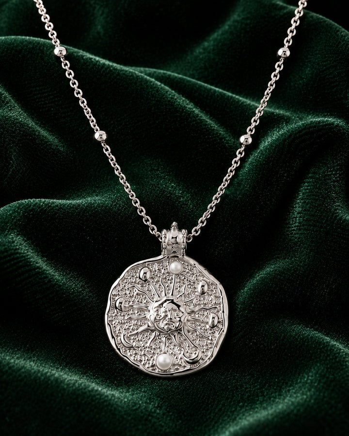 Elli Jewellery rhodium plated medallion necklace with sun motif and pearl accents on a satellite ball chain.