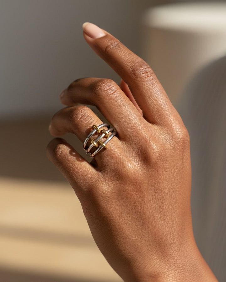 Elli Jewellery rhodium plated multilayer stacking rings in silver and gold tones worn on a hand