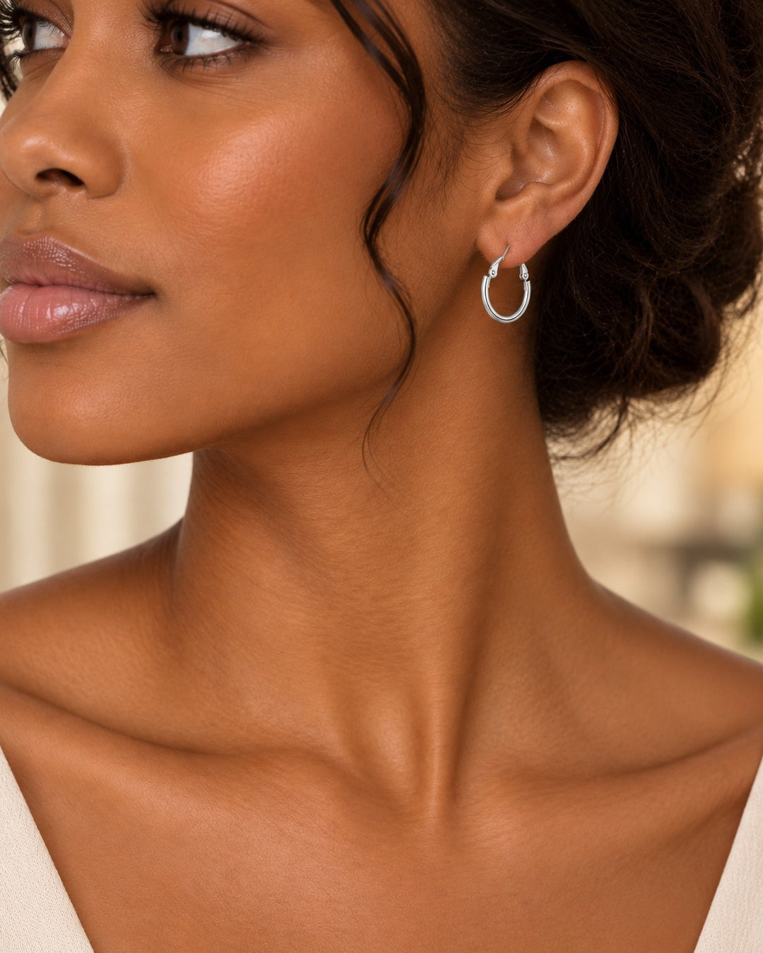 Elli Jewellery classic rhodium plated hoop earrings with a polished silver finish worn by a woman