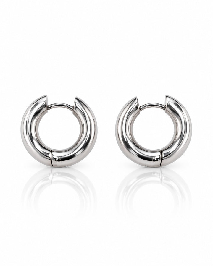 Elli Jewellery rhodium plated waterproof huggie hoop earrings with a sleek silver-toned finish and hinged closure.