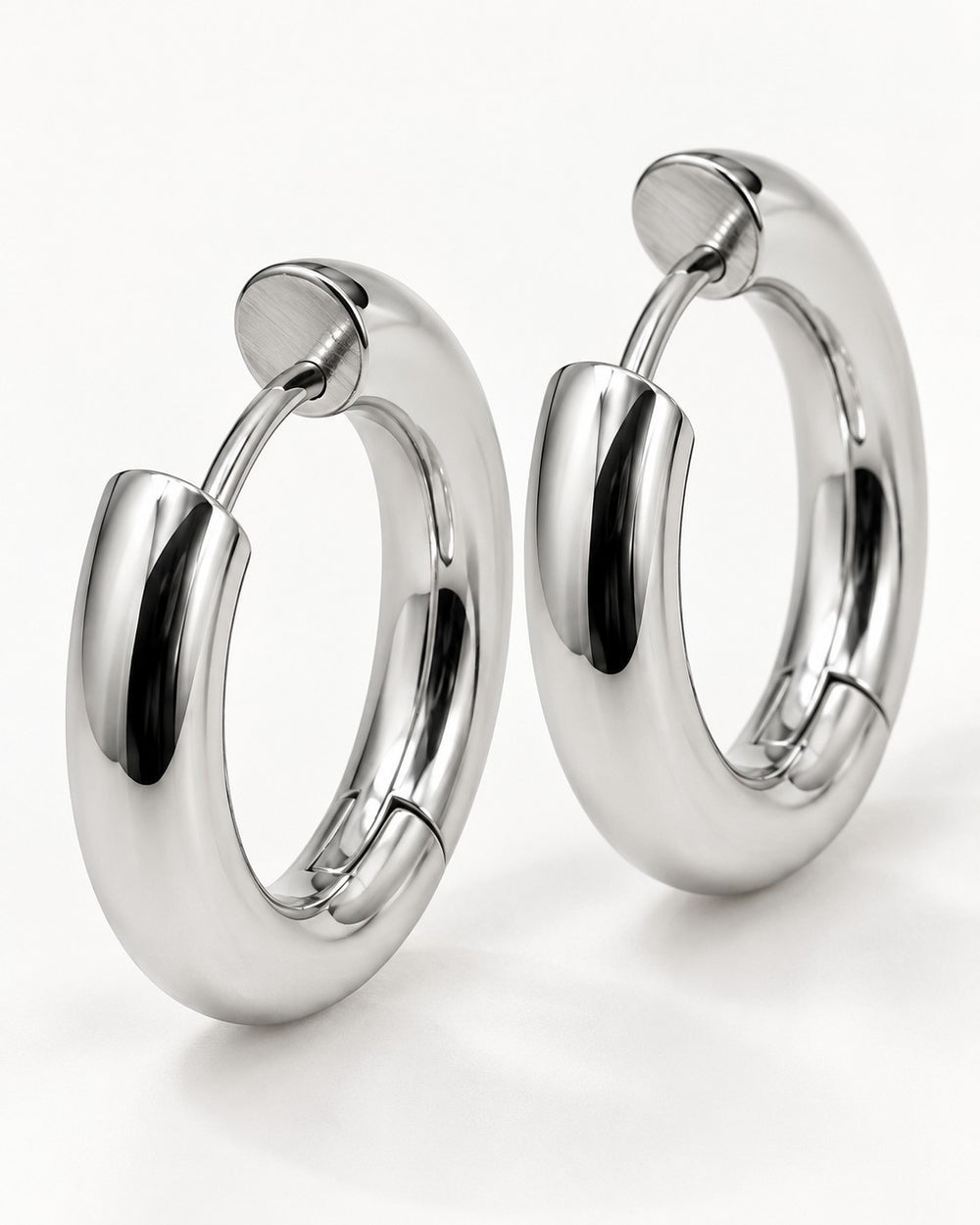 Elli Jewellery rhodium plated waterproof mid huggie hoop earrings with a polished silver finish on a white background.