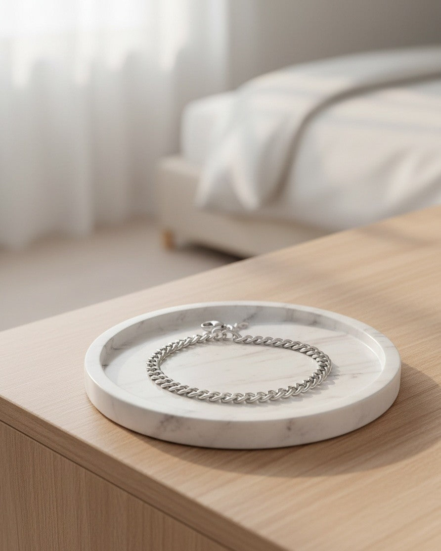 Elli Jewellery rhodium plated waterproof rope chain bracelet resting on a white marble tray in a bright bedroom.