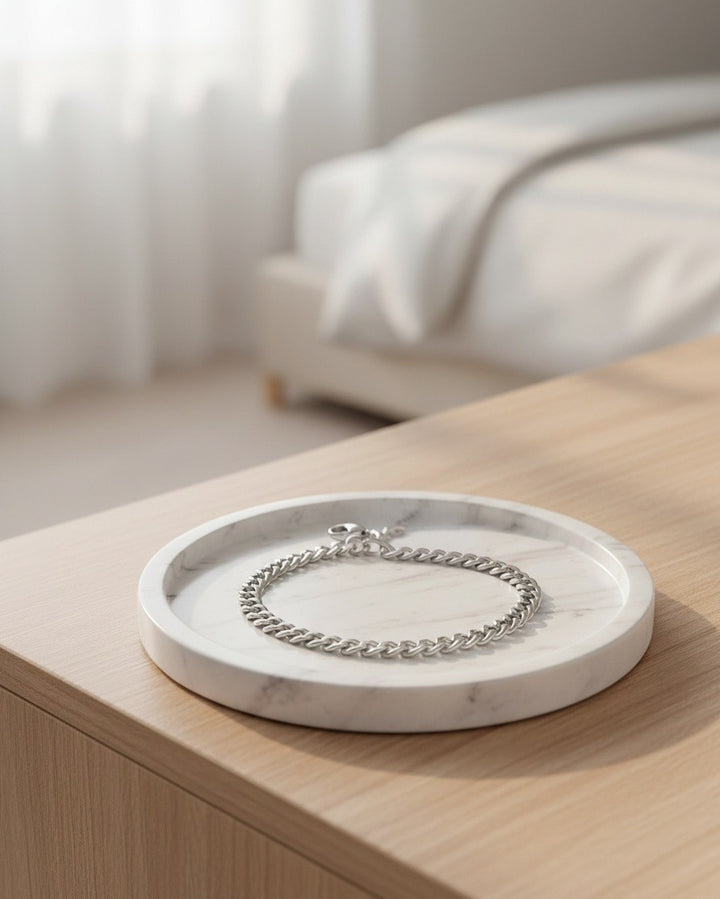 Elli Jewellery rhodium plated waterproof rope chain bracelet resting on a white marble tray in a bright bedroom.