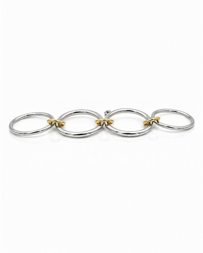 Elli Jewellery rhodium plated silver and gold tone multilayer stacking rings linked together on a white background.