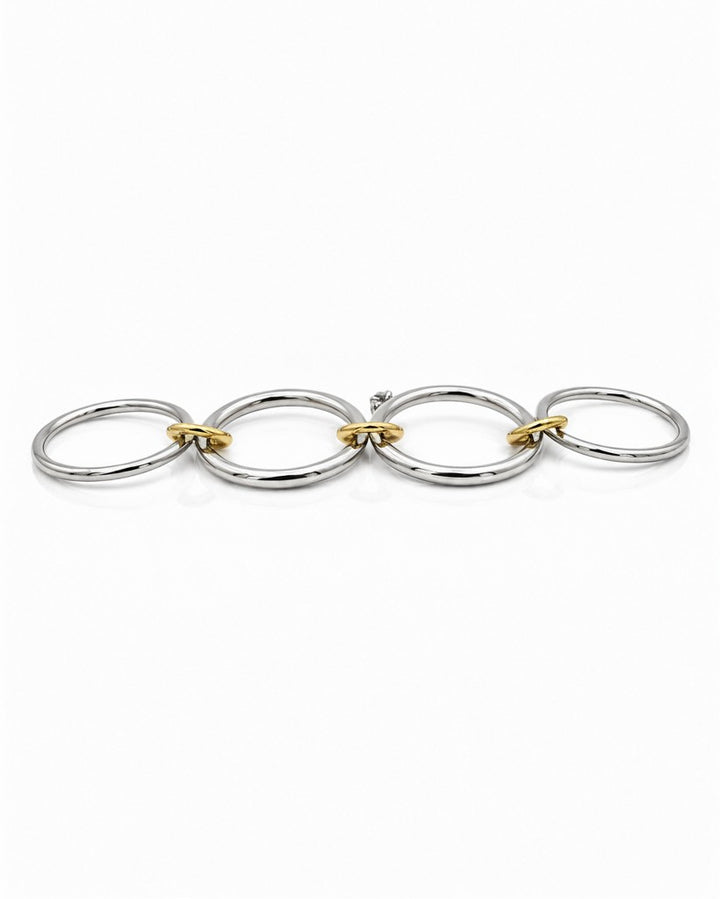 Elli Jewellery rhodium plated silver and gold tone multilayer stacking rings linked together on a white background.