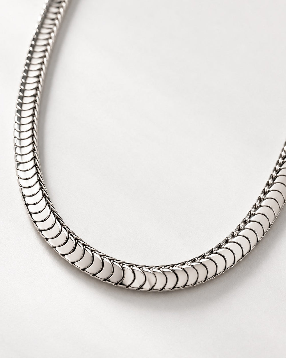 Elli Jewellery silver toned snake chain necklace with a polished, fluid, and minimalist design on a white background.