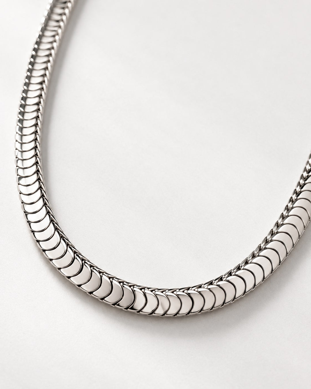 Elli Jewellery silver toned snake chain necklace with a polished, fluid, and minimalist design on a white background.