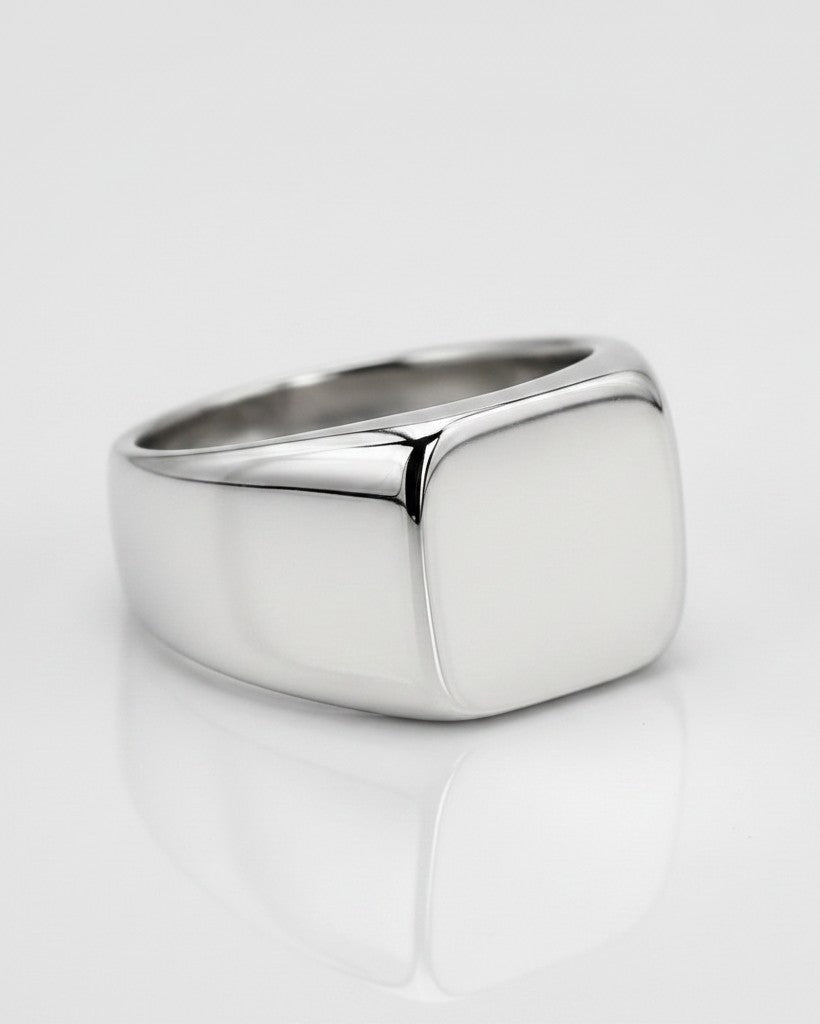 Elli Jewellery polished silver stainless steel classic signet ring with a smooth square face on a white background.